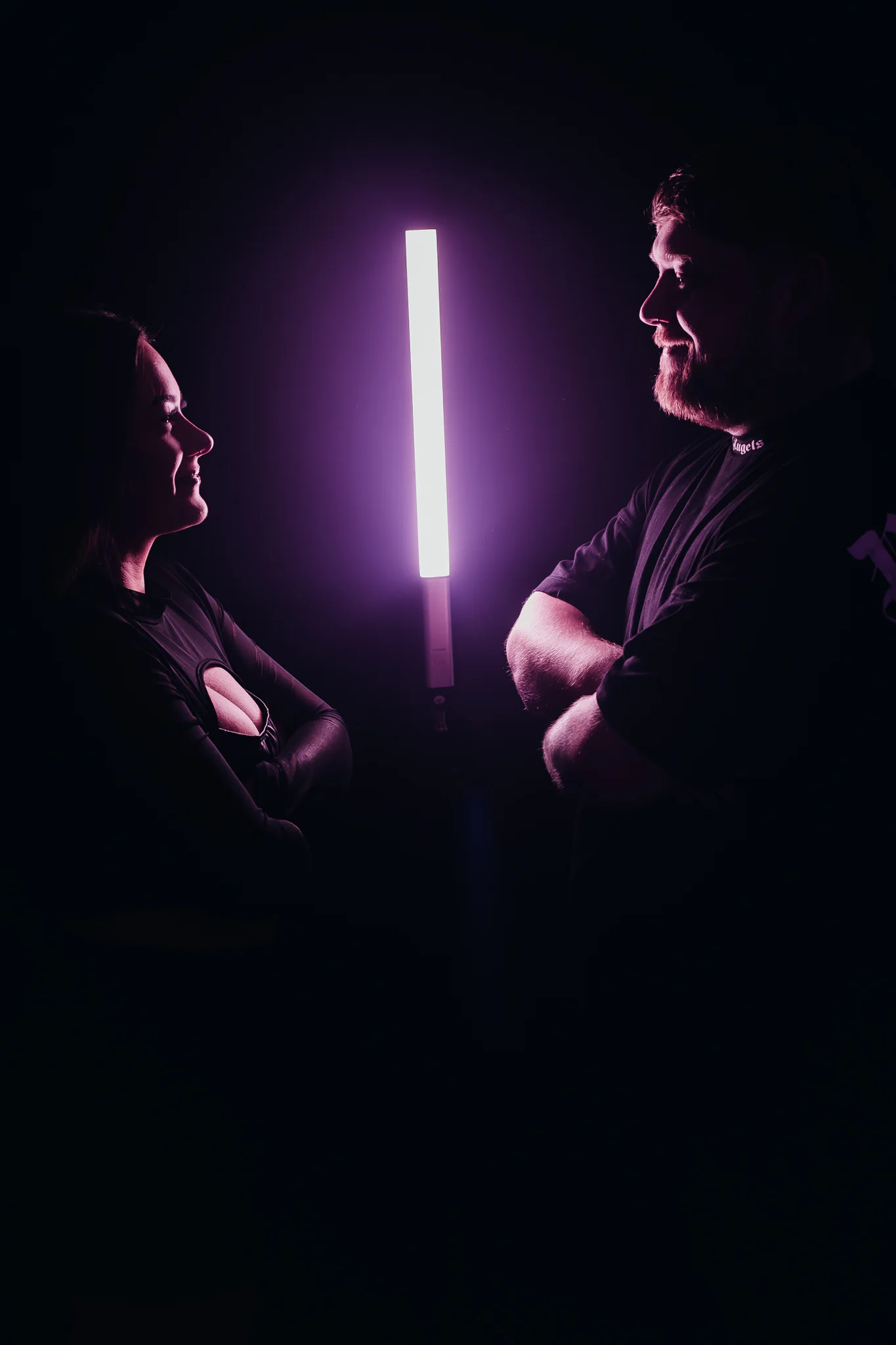 Jamie & Britney of Moodswing facing each other beside a vertical light